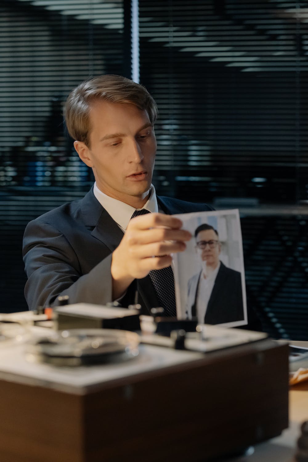 How To Manage Your Prior Records To Be More Productive In The Workforce: A Guide 1 Man in a Suit Sitting in a Room and Holding a Picture of a Man