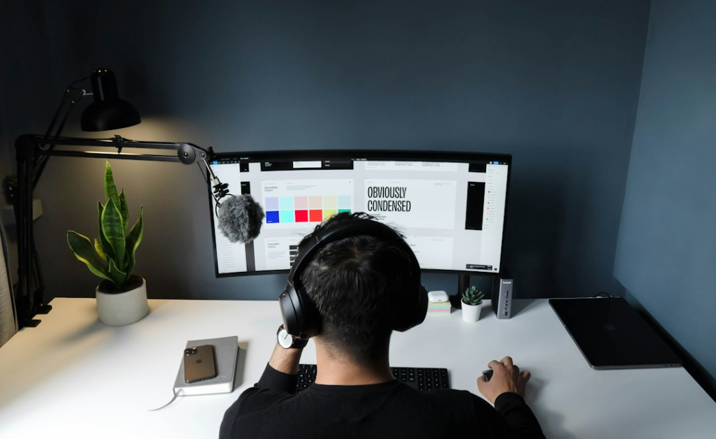Man In Black Shirt Sitting In Front Of Computer man in black shirt sitting in front of computer
