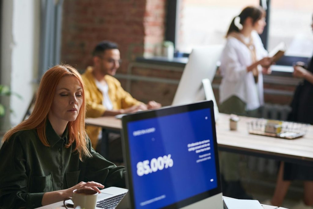 Maximizing Business Productivity: How Equity Firms Drive Growth 3 Woman Seated Working on Computer