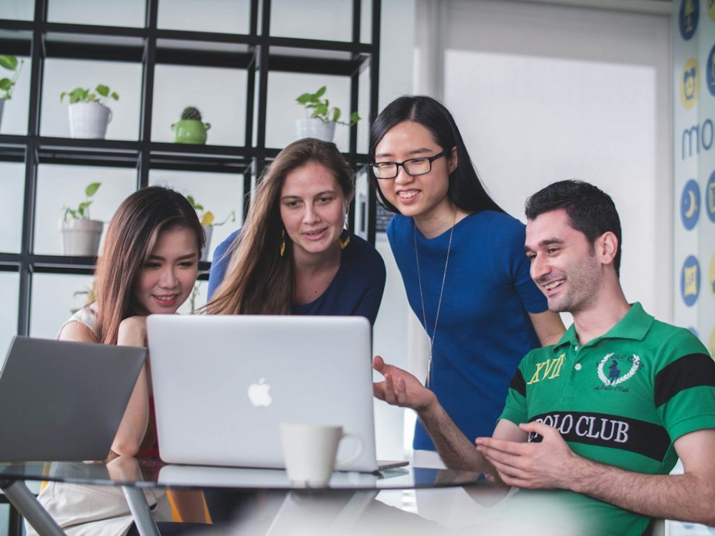 Affiliate Marketing Reinvented: The Whys And Hows Of Leveraging Safeopt 3 four people watching on white MacBook on top of glass-top table