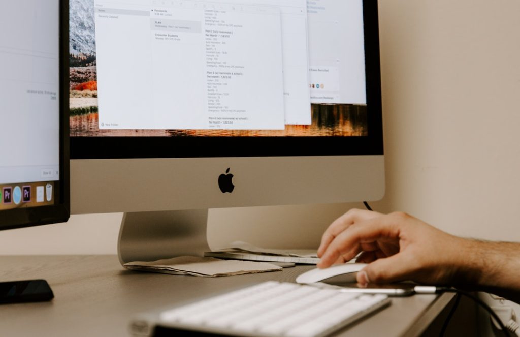 8 Expert Tips To Maximize Engagement And Elevate Your Online Brand 1 person holding white Apple Magic Mouse beside iMac and keyboard