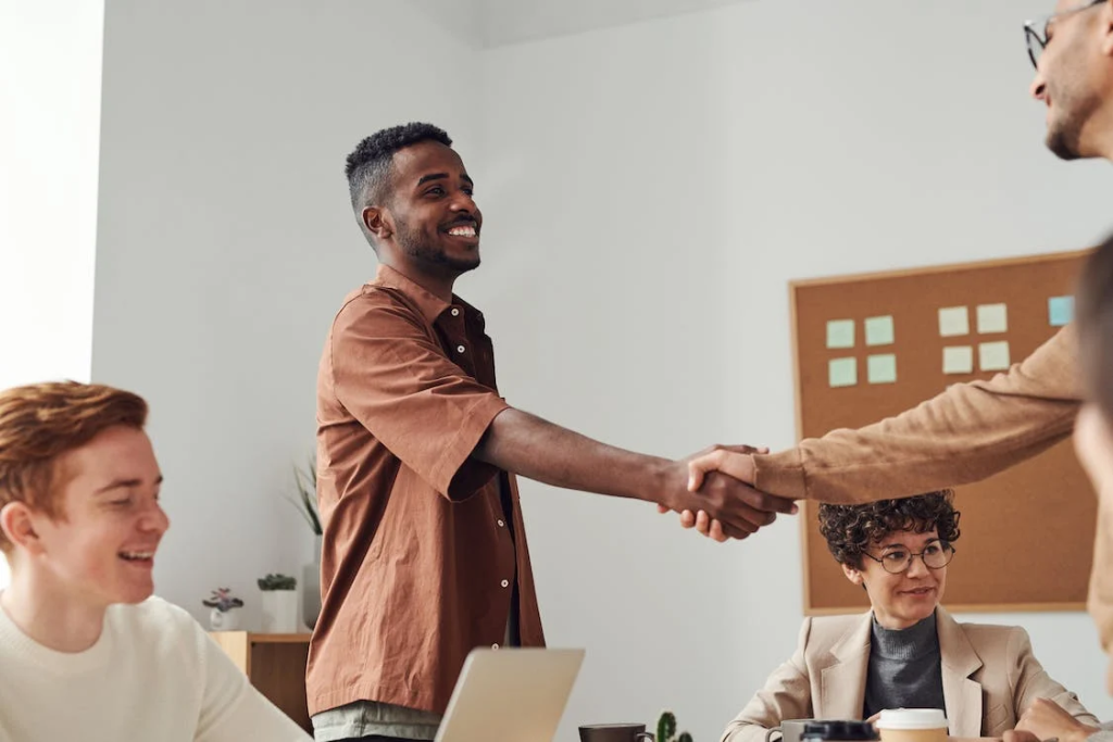 How To Boost Hiring Processes For Better Outcomes 1 Man in Brown Sport Shirt Shaking Hands of Man