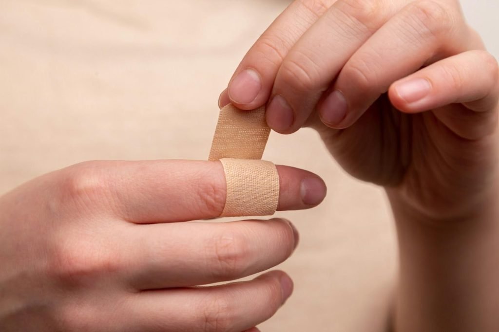 Work Injuries: Proven Ways To Legally Protect Your Rights 1 person with band aid on middle finger