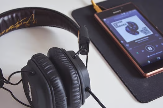 Sonic Branding 101: Crafting A Memorable Sound For Your Marketing Efforts 1 Black Corded Headphones Beside Sony Android Smartphone