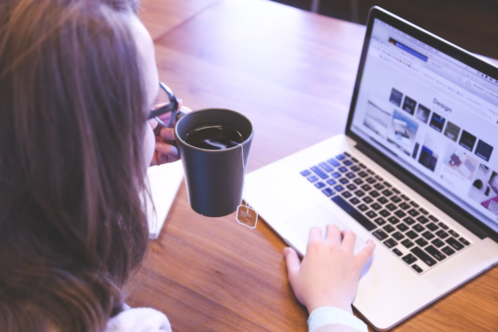 6 Digital Tools To Manage Your Online Stores &Amp; Boost Revenue 3 woman holding tea filled mug using MacBook