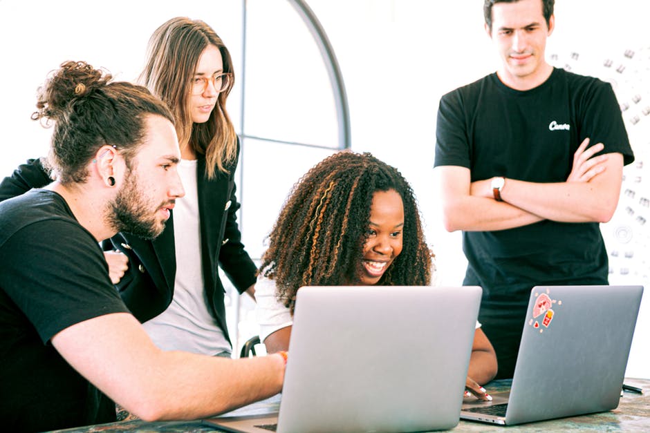 How To Make Your Tech Business More Recognizable: 6 Strategies To Follow 1 A Group of Professionals Sharing Ideas