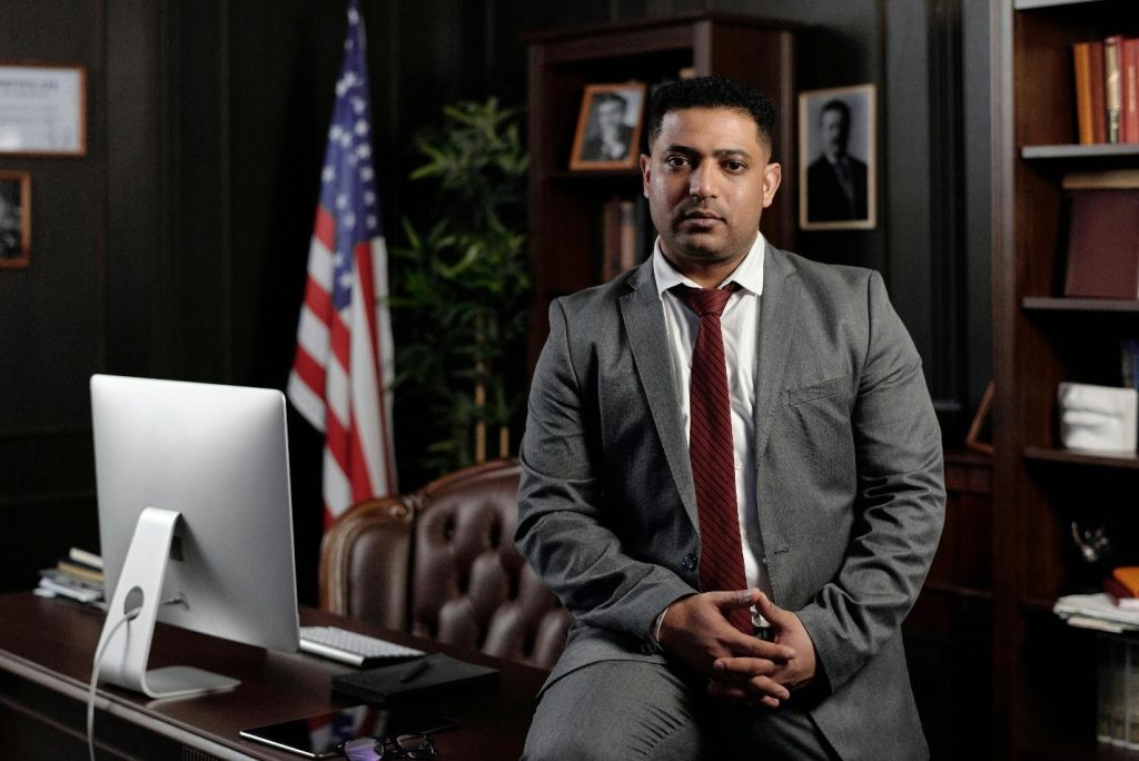 How To Protect Your Legal Rights &Amp; Get A Rightful Compensation: A Concise Guide 1 Businessman Sitting on his Desk and Looking at the Camera