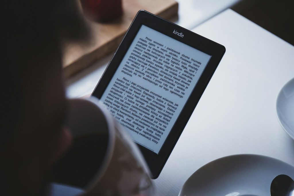 How Digital Publishing Empowers Authors: An Overview 1 turned on black Amazon Kindle e-book reader