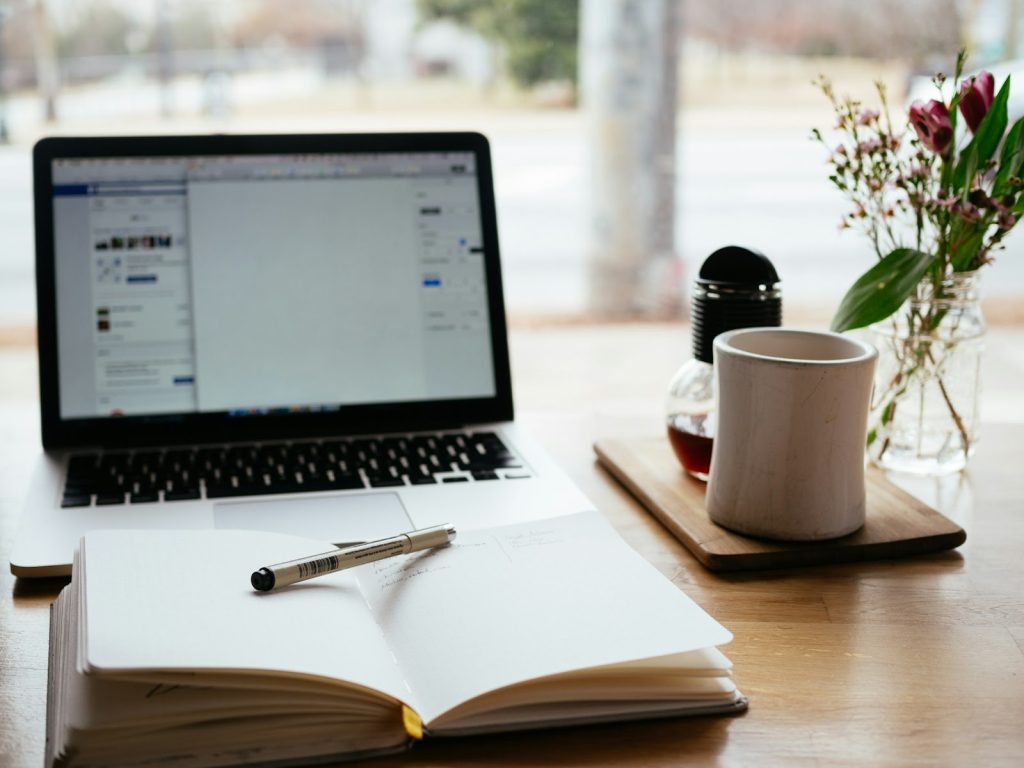 How Digital Publishing Empowers Authors: An Overview 3 MacBook Pro near white open book