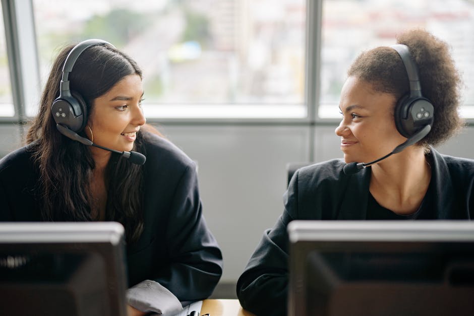 Choosing The Right Answering Service Provider: Key Considerations And Features 1 two women in wearing headsets at work