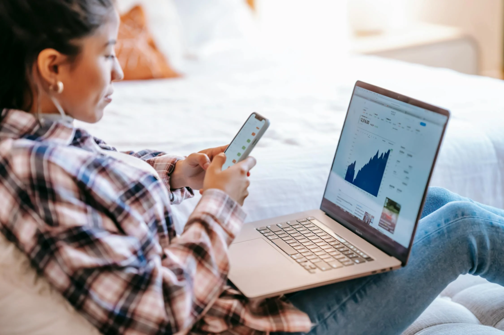 The Ultimate Guide To Selecting Investment Strategies For Leaders 1 Crop ethnic trader with smartphone and laptop on bench indoors