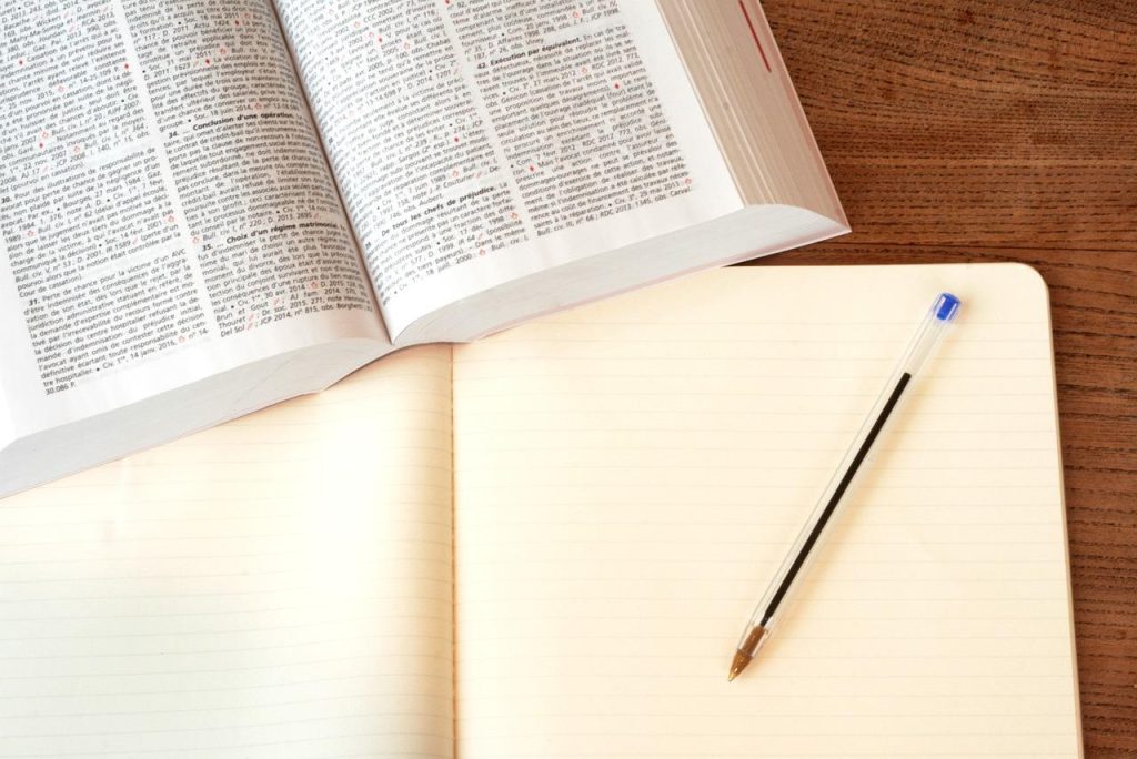Ultimate Guide To Understanding Premises Liability Laws For Your Business 3 note book and dictionary