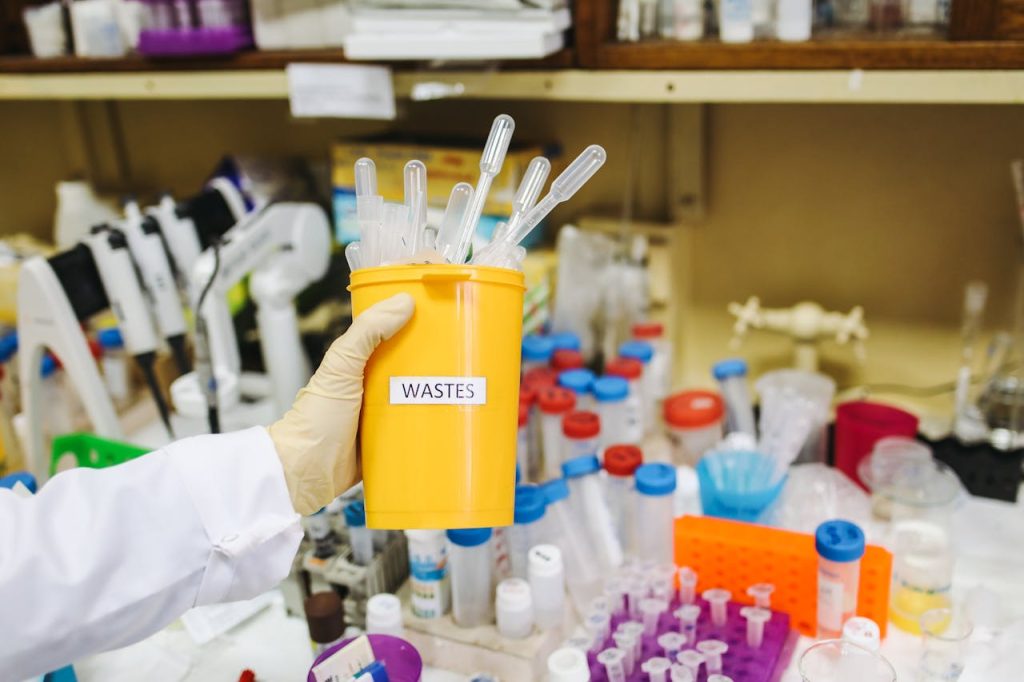 Safe Handling And Disposal Of Clinical Waste: A Guide For Healthcare Facilities 1 Person Holding Plastic Container