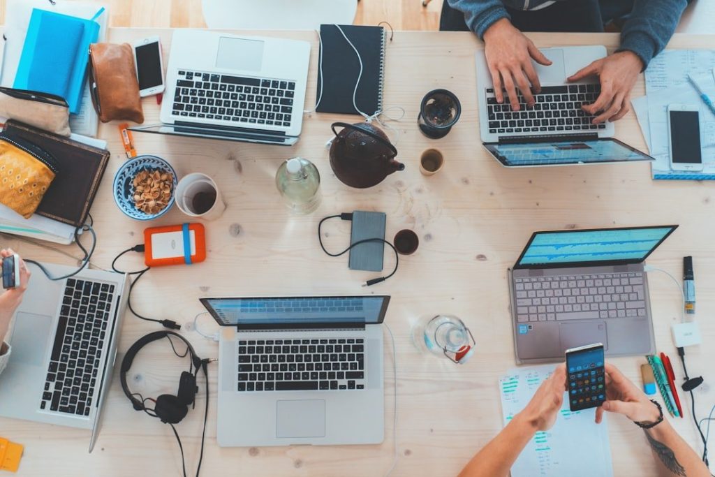 Building A Unique Identity For Your Indie Game: Key Lessons 1 people sitting down near table with assorted laptop computers
