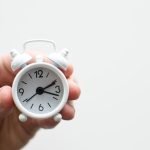 Mastering Open Hour Scheduling: A Guide For Better Time Management 21 person holding white mini bell alarmclock