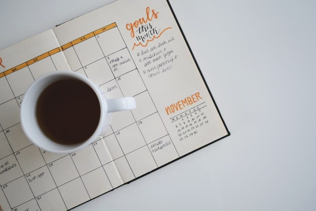 Mastering Open Hour Scheduling: A Guide For Better Time Management 13 white ceramic mug with coffee on top of a planner