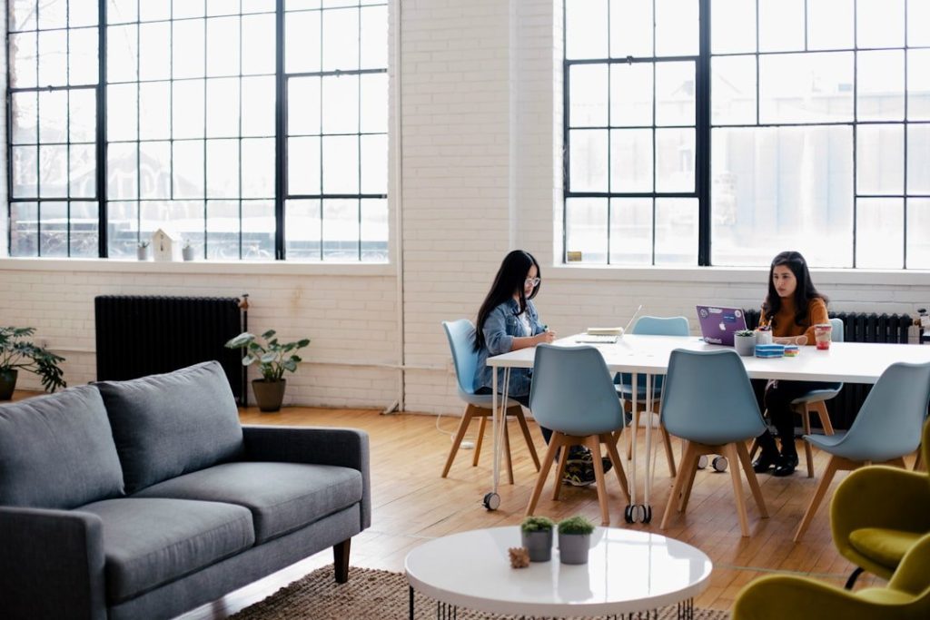 Mastering Open Hour Scheduling: A Guide For Better Time Management 15 two women sitting in front of white table