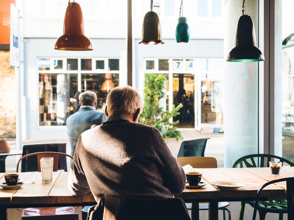 How Seniors Can Improve Their Cash Flow 1 man in chair with table beside coffee