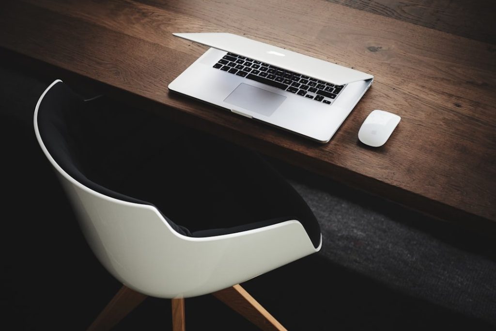 Exploring The Benefits Of Ergonomic Chair Desk Glides 1 Apple MacBook beside computer mouse on table