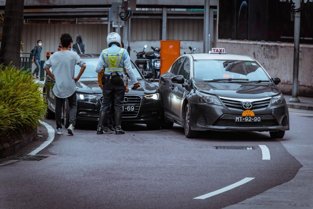 How Legal Representation Can Maximize Your Compensation: Key Benefits After A Car Accident 1 man in white and black stripe shirt and black pants standing beside black car during daytime