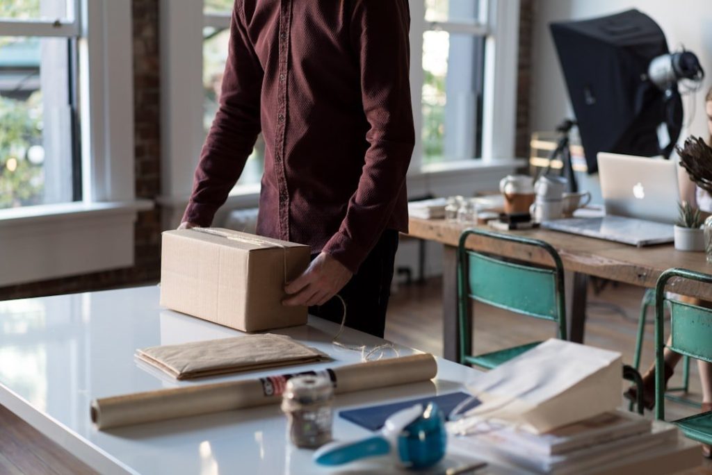 Key Strategies To Enhance Efficiency In Small And Medium Enterprises 1 person holding cardboard box on table