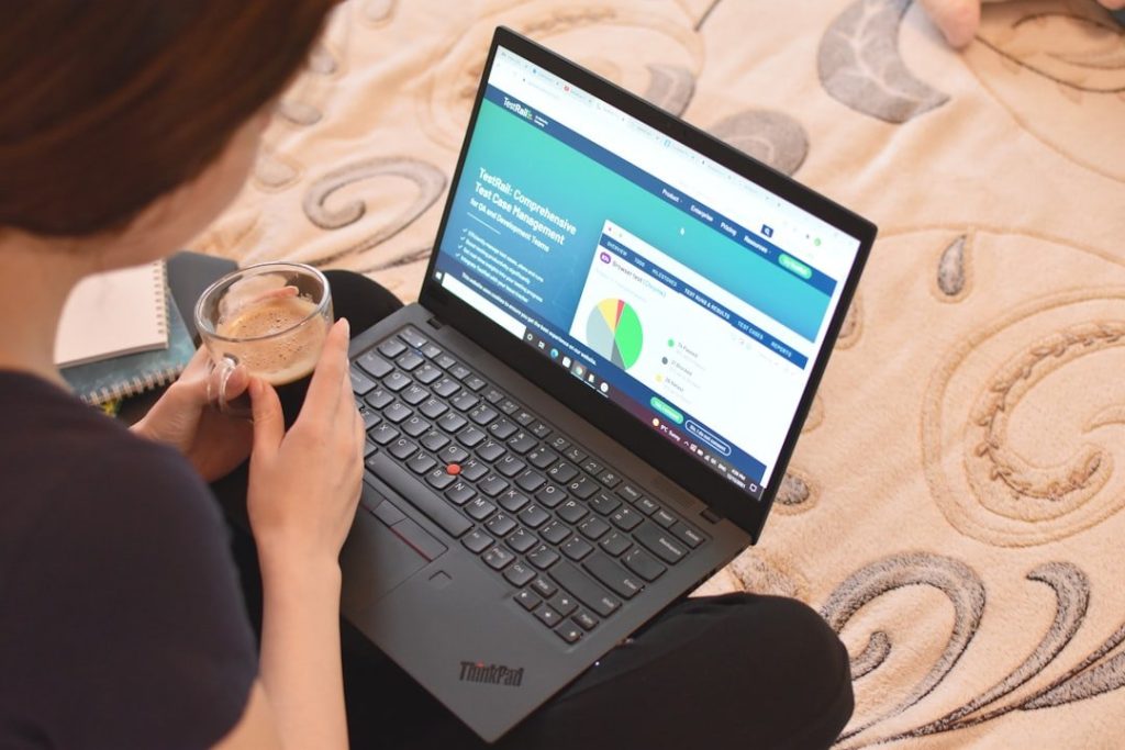 When Productivity Meets Ppc: How Learning Ad Skills Becomes A Growth Habit 1 a woman sitting on a bed looking at a laptop