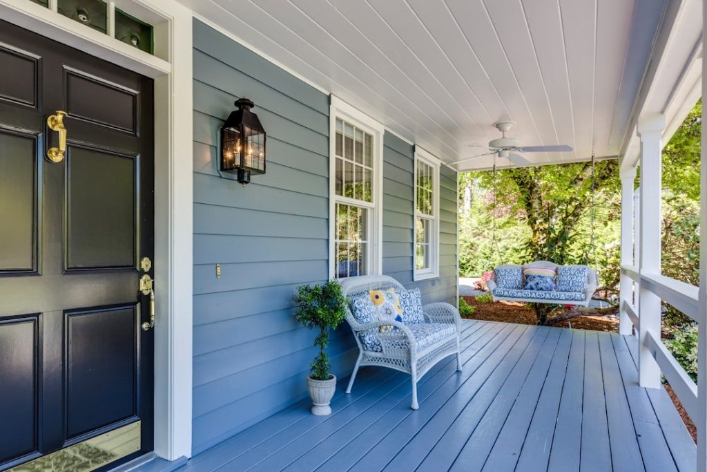Tips For Maintaining Quality During Home Exterior Projects 1 a porch with two chairs and a table on it