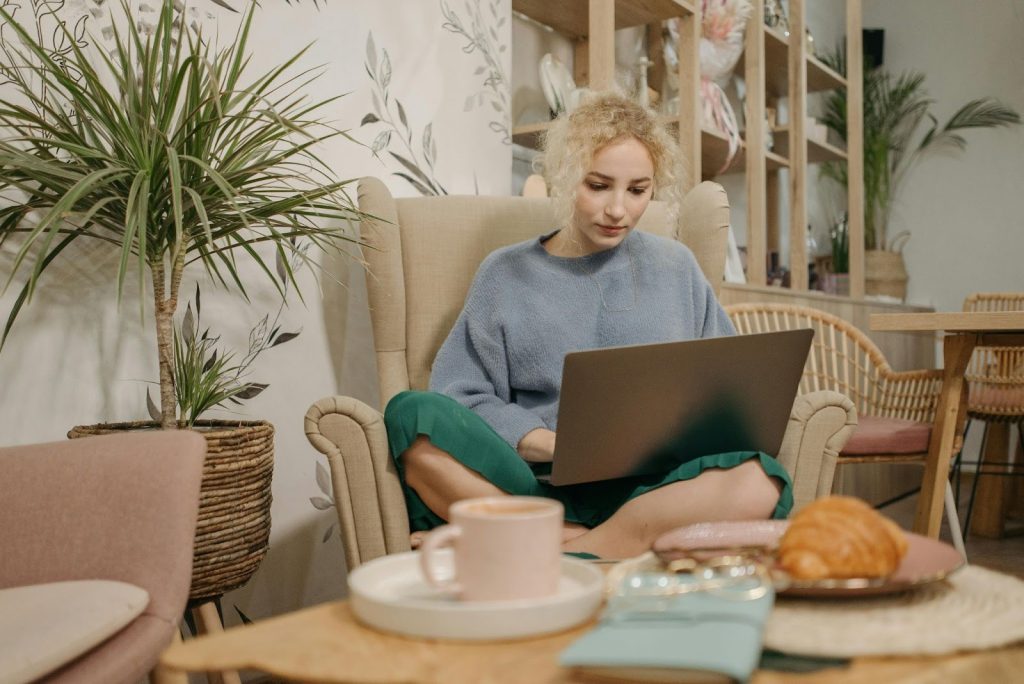 Why Functionality Matters Most In A Compact Home Office Setup 1 Woman working on laptop in cafe