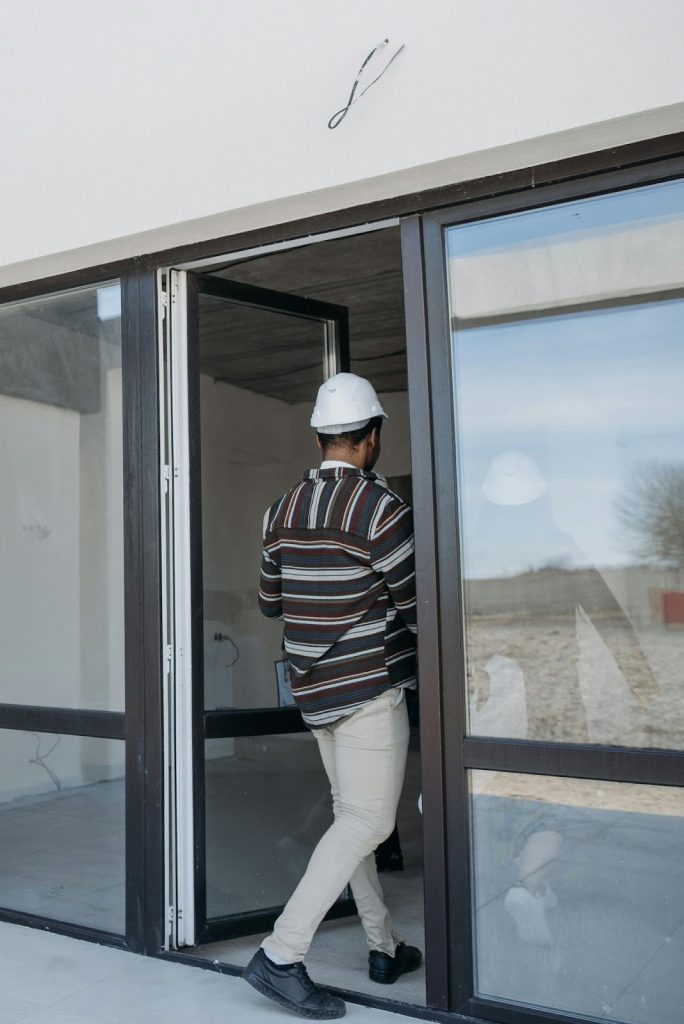 Reliable Comfort Solutions For Homes And Businesses 1 Person wearing helmet near doorway.