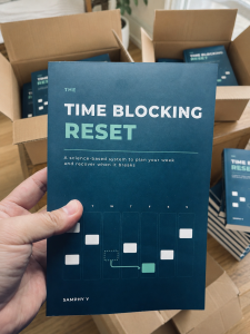 From “Someday” To Published: Writing The Time Blocking Reset 2 Samphy Y holding the paperback edition of The Time Blocking Reset.
