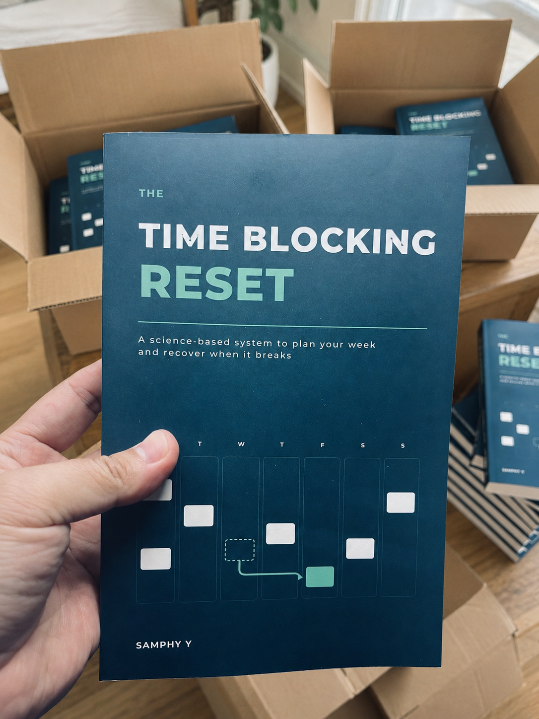 From “Someday” To Published: Writing The Time Blocking Reset 2 Samphy Y holding the paperback edition of The Time Blocking Reset.